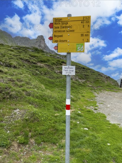 Information board Sign with arrow-shaped signpost at the top of the Splügenpass Passo dello Spluga Signpost for mountain hikers with the inscription Splügen Monte Spluga Bergseeli Lago Azzurro, Splügenpass Passo dello Spluga, Lombardy, Italy, Grisons, Switzerland