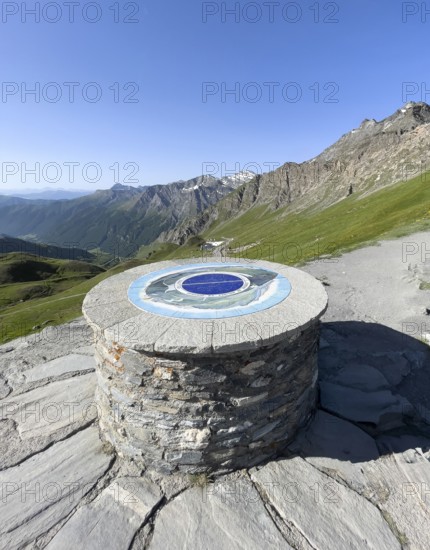Front orientation board on stone plinth at viewpoint on third highest asphalted pass in the Alps highest border pass 2744 m high Col Agnel Colle dell' Agnello Pass in the high Alps Alpine pass above tree line via southern ascent mountain road Alpine road, Col Agnel, Colle dell'Agnello, Pontechianale, Piedmont, Italy