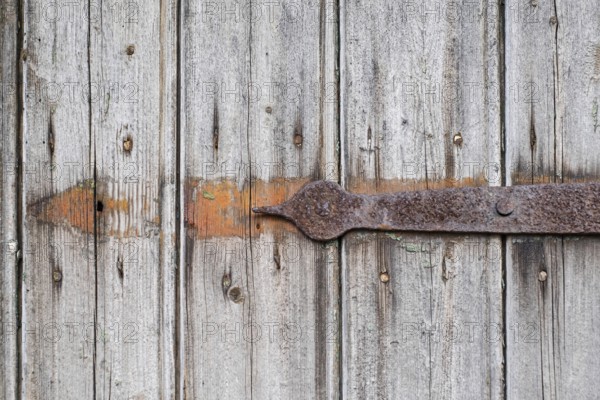Detail of an old wooden door with rusty metal fittings, texture, background, Münsterland, North Rhine-Westphalia, Germany