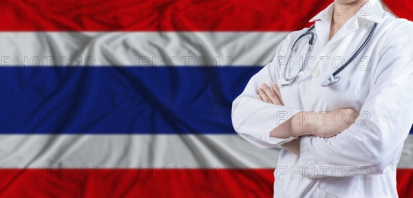 Doctor with crossed arms on Thailand flag. Thai health and care concept. Female doctor on Thailand flag