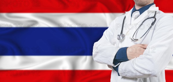 Thailand healthcare concept. Male doctor on Thailand flag. Doctor with crossed arms on Thailand flag