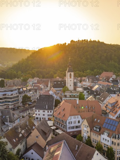 Historic old town with church tower and surrounding hills in the golden evening light, small town pearl Nagold, Black Forest, Germany