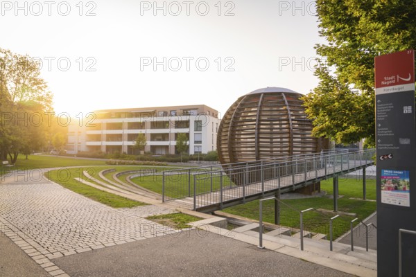 Modern architecture with a spherical building in the warm evening light, small town of Perle Nagold, Black Forest, Germany