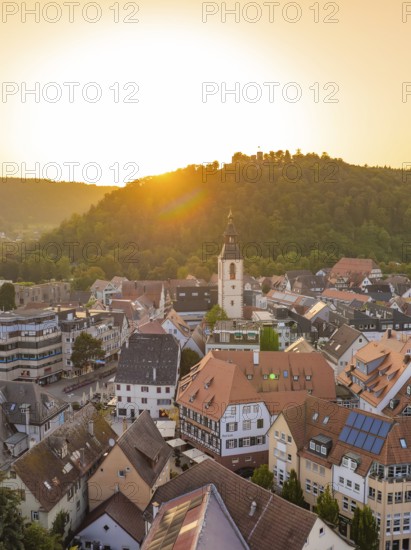 Sunny view of an old town with church and hills in the background at sunset, small town pearl Nagold, Black Forest, Germany