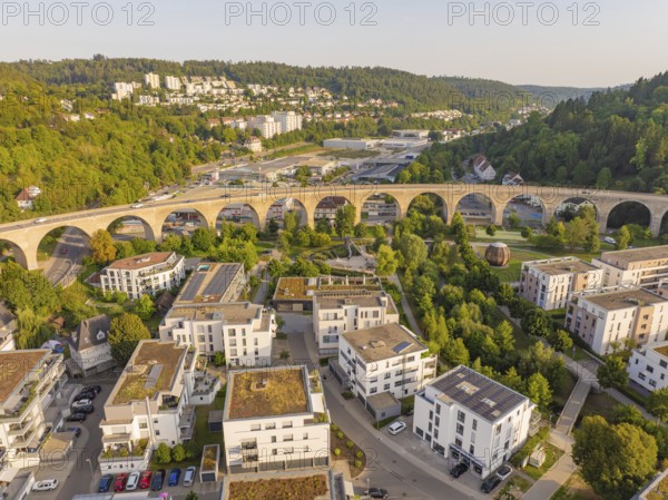 Aerial view of a viaduct in the middle of a residential area and the surrounding forests, small town of Perle Nagold, Black Forest, Germany