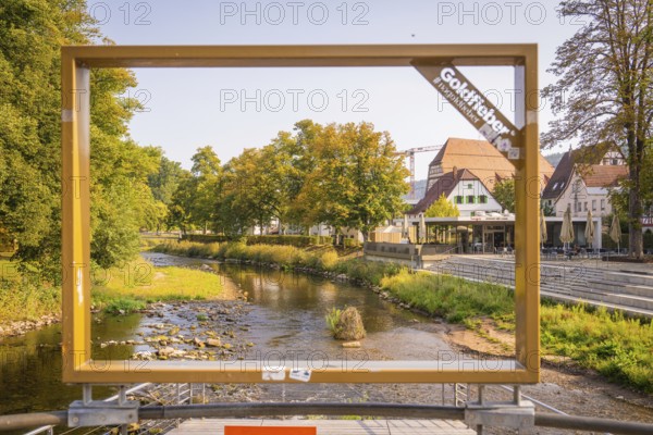 A river, framed by a large frame, in an urban landscape, small town pearl Nagold, Black Forest, Germany