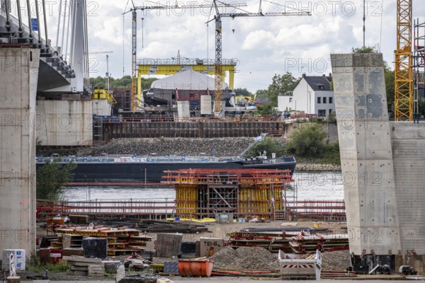 New construction of the second motorway bridge Neuenkamp of the A40, over the Rhine near Duisburg, parallel to the already existing first bridge, most of the new bridge piers are in place, two first bridge segments are finished and have already been moved towards the river on both sides of the Rhine, full completion is planned for 2028, North Rhine-Westphalia, Germany
