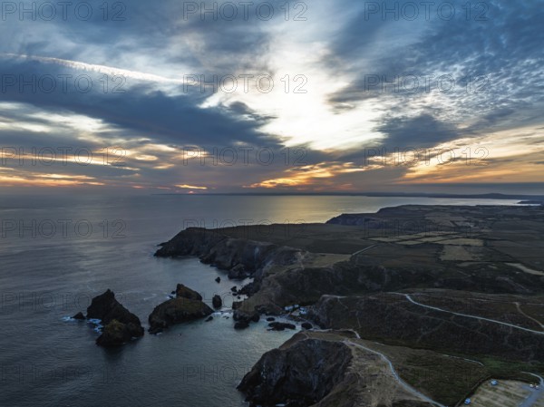 Sunset over Kynance Cove from a drone, Mount's Bay, Lizard Point, Cornwall, England, United Kingdom