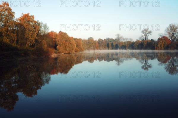 Calm pond with autumn trees and clear reflection, Krefeld