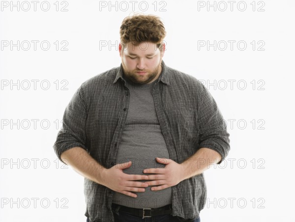 Overweight young man looks worried and holds his hands on his stomach, AI generated, AI generated