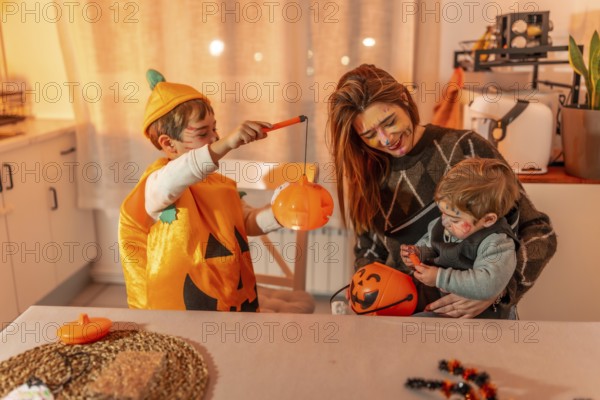 Family wearing halloween costumes and makeup are playing with pumpkin baskets in a kitchen
