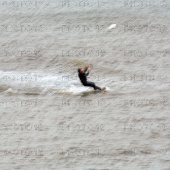 Kitesurfer in the surf, wiping effect, long exposure, Sankt Peter-Ording, Eiderstedt peninsula, Wadden Sea National Park, North Frisia, Schleswig-Holstein, Germany