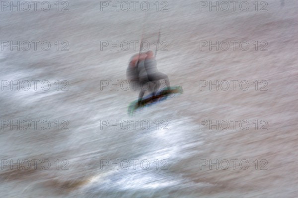 Kitesurfer jumping in the surf, wiping effect, long exposure, Sankt Peter-Ording, Eiderstedt peninsula, Wadden Sea National Park, North Frisia, Schleswig-Holstein, Germany