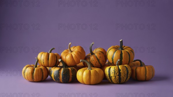 Small orange pumpkins with stripes on purple banner with copy space. Generative ai, AI generated
