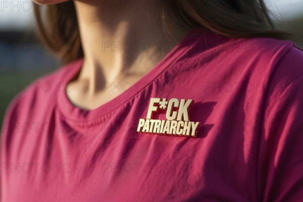 Close-up of gold pin reading FCK patriarchy on pink t-shirt. Bold feminist statement against gender inequality and systemic oppression. Generative ai, AI generated