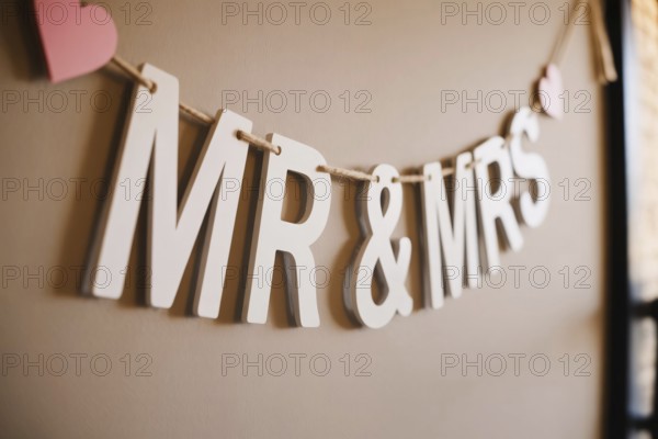 Close up of Mr & Mrs wedding garland with hearts. Romantic wedding decoration detail. Generative ai, AI generated