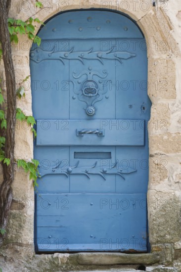 Blue door in a historic house façade, Vaison-la-Romaine, Provence, France