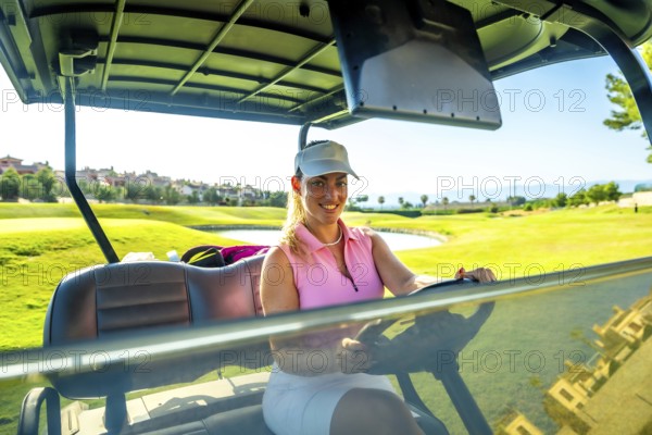 Smiling woman enjoying a sunny day while driving a golf cart through a picturesque golf course, surrounded by lush greenery and vibrant landscapes