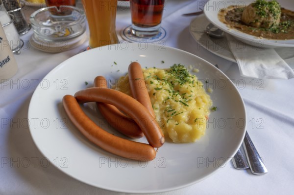 Viennese sausages with potato salad served in a beer garden, Bavaria, Germany