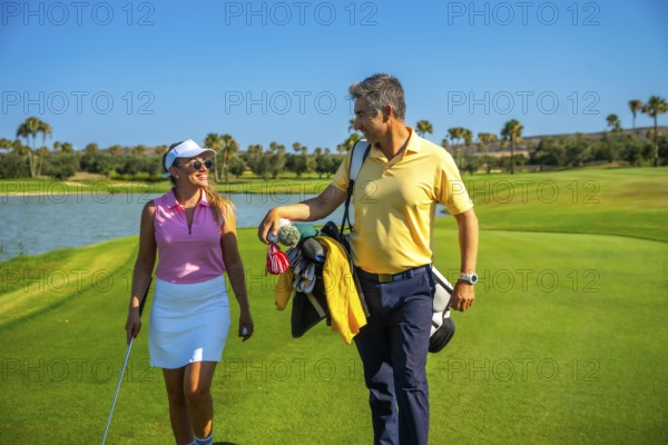 Couple of golfers walking and chatting on a picturesque golf course under a bright sun, enjoying a leisurely day filled with laughter and connection