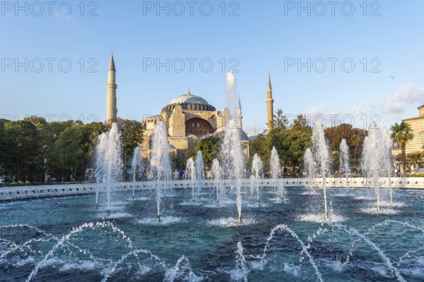 Fountains splashing water in front of the hagia sophia in istanbul, turkey, during a sunny day