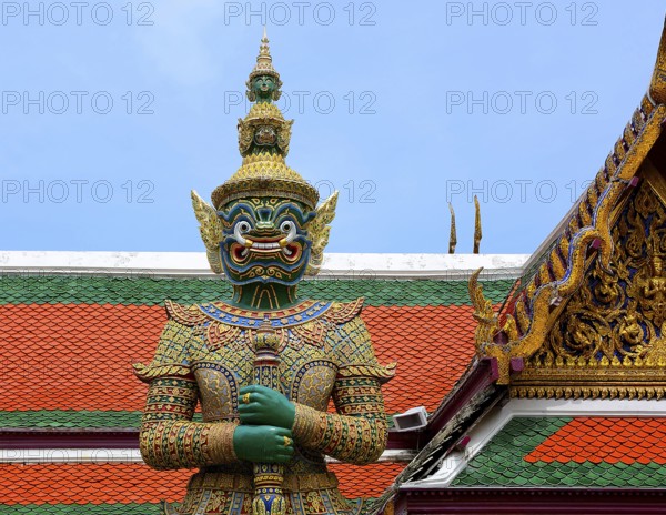 Colorful giant yaksha statue guarding the entrance of wat phra kaew, temple of the emerald buddha, grand palace, bangkok, thailand