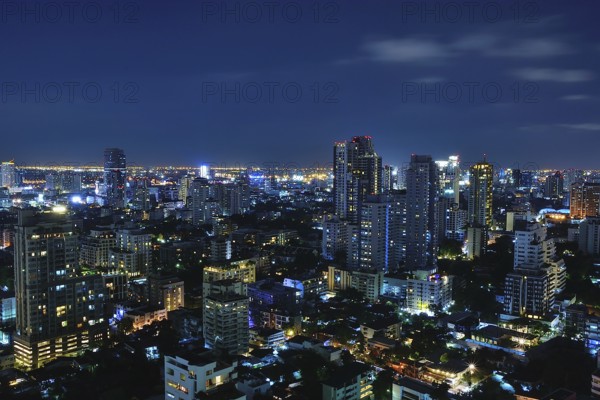 Bangkok's vibrant skyline at night, showcasing illuminated skyscrapers and bustling urban life in thailand's capital