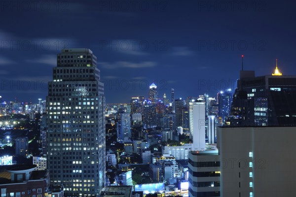 Modern skyscrapers dominating the bangkok skyline at night, showcasing thailand's vibrant urban landscape