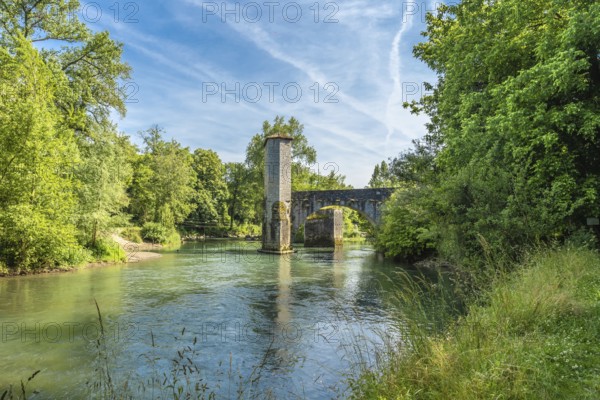 Scenic view of the historic stone bridge over the gave d'oloron river, surrounded by lush greenery, in the charming town of sauveterre de bearn, france