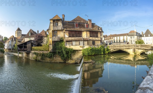 Picturesque view of the canal flowing through salies de bearn, a charming village located in the pyrenees atlantiques department of france