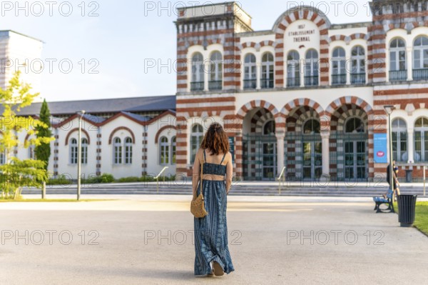 Young woman visiting the famous thermal baths in salies de bearn, a popular spa town in the pyrenees atlantiques region of france