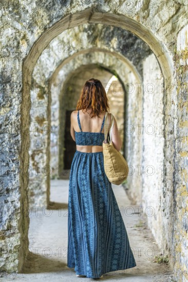 Tourist admiring the arches of sauveterre de bearn in france, enjoying a summer vacation exploring historical landmarks