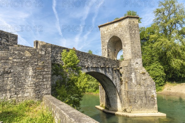 The historic stone bridge in sauveterre de bearn, france, stands majestically over the gave d'oloron river, a testament to medieval architecture