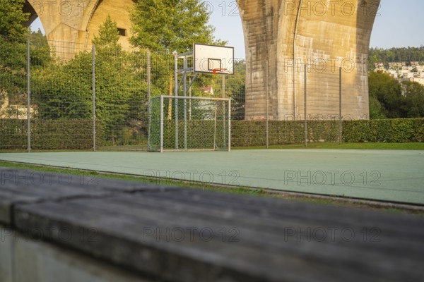 Outdoor basketball court under a large concrete bridge in an urban environment, Nagold, Calw district, Black Forest, Germany