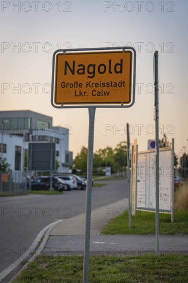 Town sign of Nagold on a street with modern buildings in the background, Nagold, district of Calw, Black Forest, Germany