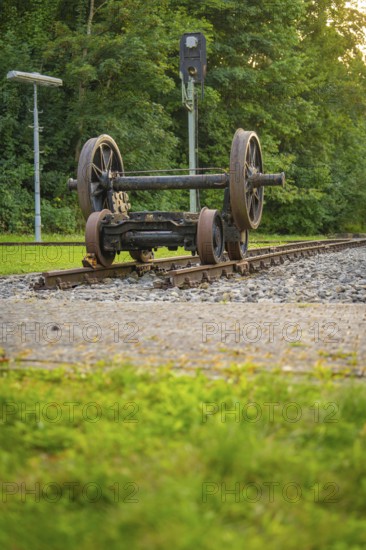 Two upturned train wheels on tracks against a green background. Atmosphere of peace and nature, Nagold, district of Calw, Black Forest, Germany