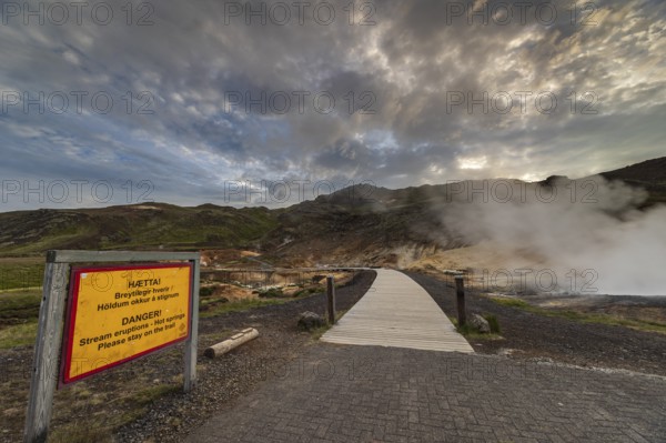 Hot springs, geothermal field, danger sign, cloudy, evening mood, backlight, summer, Krysuvik, Reykjanes Peninsula, Iceland