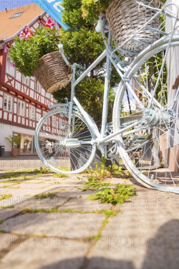 Close-up of a bicycle in front of half-timbered houses in sunlight, small town of Perle Calw, district of Calw, Germany