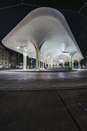 Stylish bus stop at night with illuminated architectural designs, Munich, Germany
