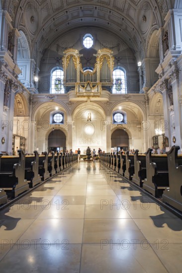 Solemn interior view of a church with altar and organ in the background, Munich, Germany