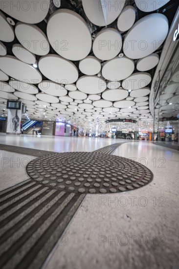 Futuristic airport with round ceiling panels and modern ambience, Munich, Germany