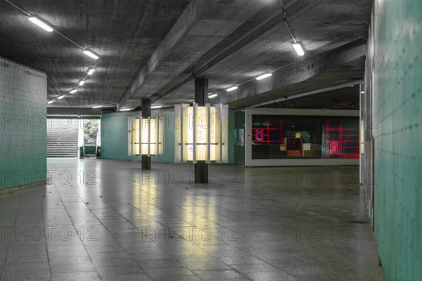 A modern, urban tunnel with coloured neon lights creates an industrial-looking atmosphere, Munich, Germany
