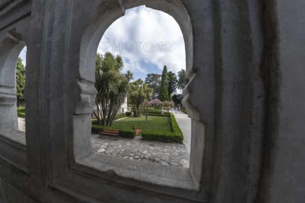 Lush gardens, framed by ornate stone arches, offer a tranquil escape in the heart of istanbul, turkey