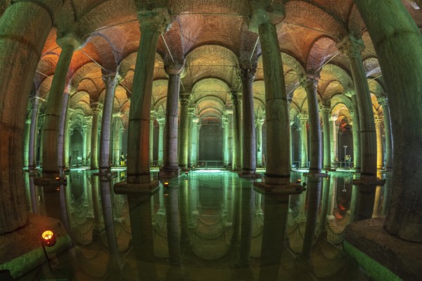 Ancient underground water reservoir with many columns reflecting on the water surface and illuminated by colorful lights, creating a magical atmosphere