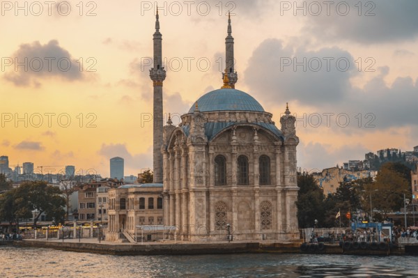 Ortakoy mosque, located on the shores of bosphorus strait, creates a picturesque scene during sunset in istanbul, turkey