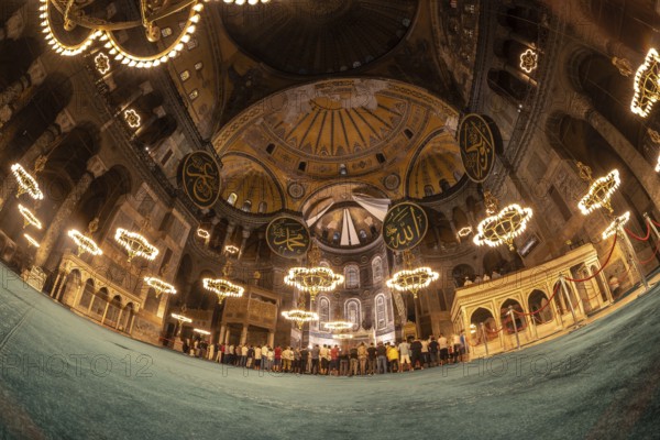 Fisheye view of muslim people praying inside the magnificent hagia sophia grand mosque in istanbul, turkey
