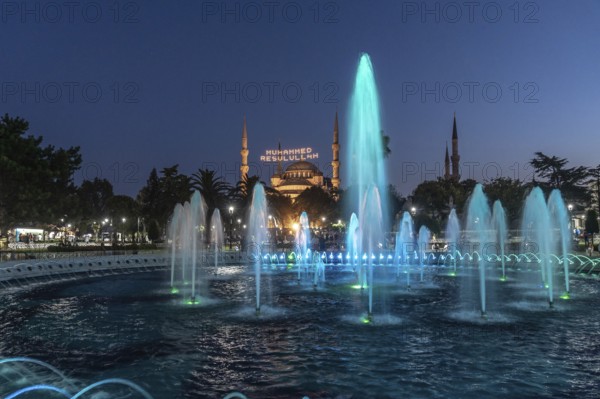 Colorful illuminated fountains enhance the beauty of hagia sophia at twilight in istanbul, creating a magical ambiance