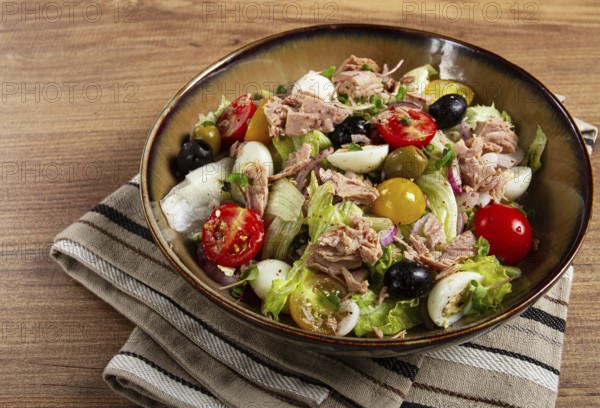 Salad with canned tuna, vegetable salad with quail eggs, lettuce, red onion, cherry tomatoes, olives, keto food, healthy food, homemade, no people