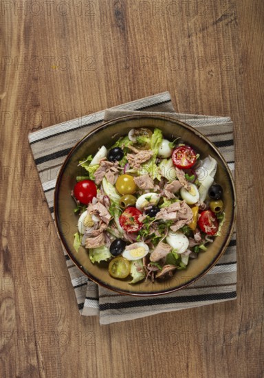 Salad with canned tuna, vegetable salad with quail eggs, lettuce, red onion, cherry tomatoes, olives, keto food, healthy food, homemade, no people