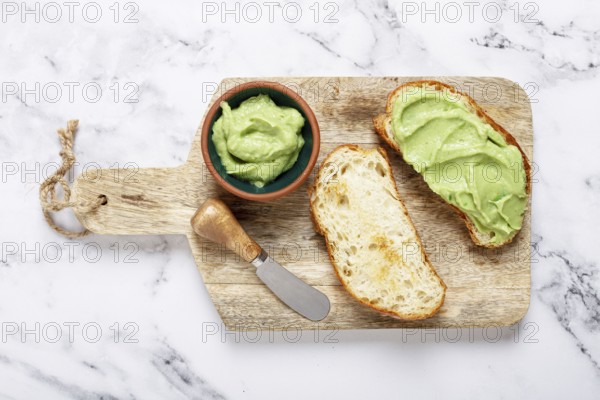 Ciabatta with avocado pasta, breakfast, on a chopping board, top view, homemade, no people